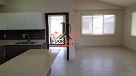 Contemporary kitchen with island, stainless steel appliances, quartz counters in condo in Panama Pacifico