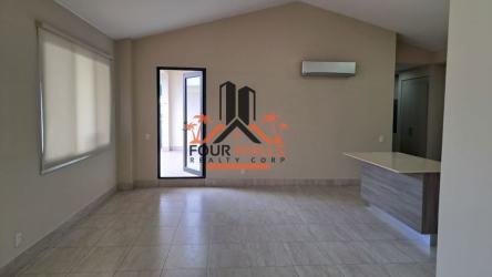 Modern living room with tiled floor, large windows, breakfast bar in Panama Pacifico condo