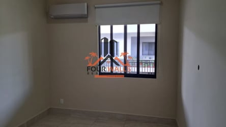 Bedroom space with split AC, tile floor, neutral tones in PH River Village Panama