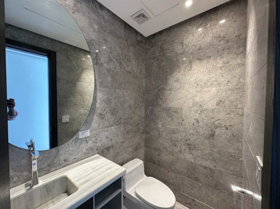 Spacious modern living room with floor-to-ceiling windows and panoramic ocean view at PH Sea Point Paitilla Panama