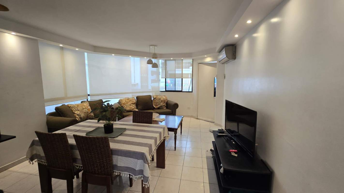 Dining area near window with urban skyline view at PH Viscaya Paitilla Panama City