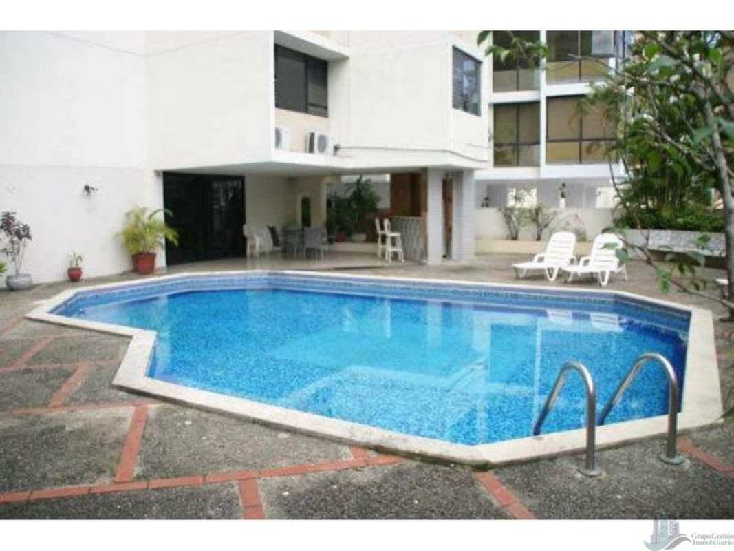 Swimming pool area with sun deck, lounge chairs, city skyline view at PH Viscaya Paitilla