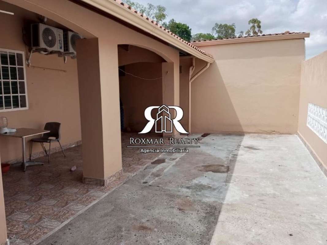 Large concrete courtyard and covered patio with arches at Brisas del Golf Panama house
