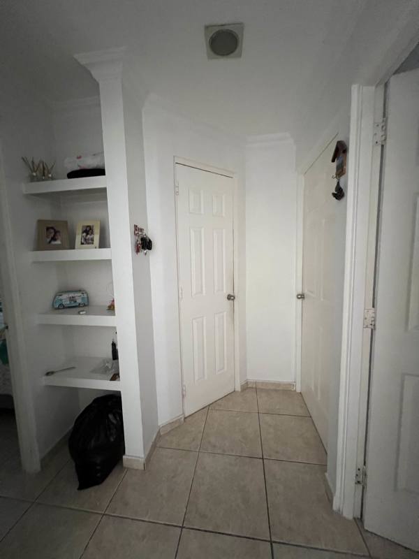 Bedroom featuring ceiling fan window with curtains air conditioning unit in Brisas del Golf Panama