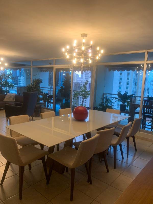 Spacious dining room with modern chandelier and balcony access at PH Andros Tower El Cangrejo Panama