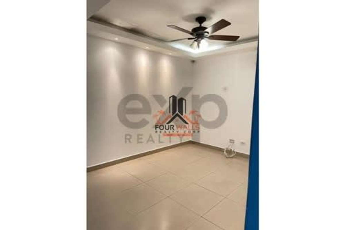 Minimalist living space with tiled floors, tray ceiling and ceiling fan in PH The View Coco del Mar Panama