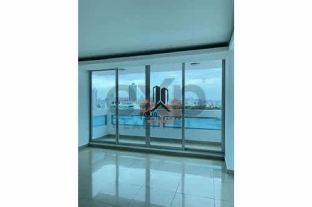 Bright living room with floor-to-ceiling windows and balcony access with ocean view at PH The View Coco del Mar