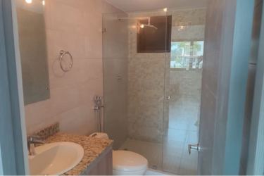 Modern bathroom granite countertop glass shower in Brisas de Coronado Coronado Panama