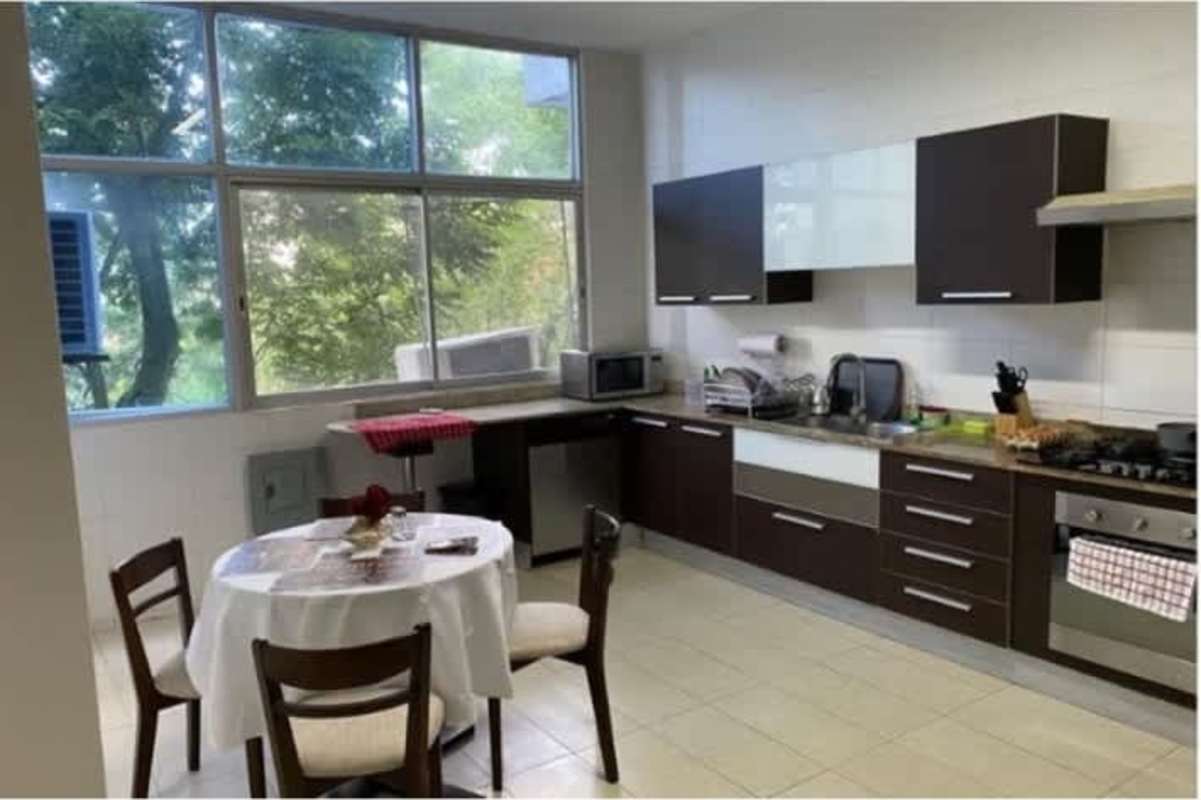Spacious kitchen with modern cabinetry and large window PH Bahía del Amador