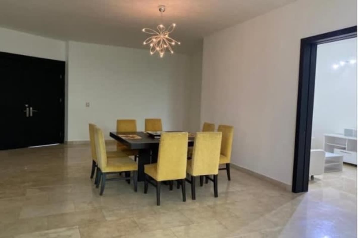 Dining room with yellow chairs, panoramic views and chandelier PH Bahía del Amador Panama