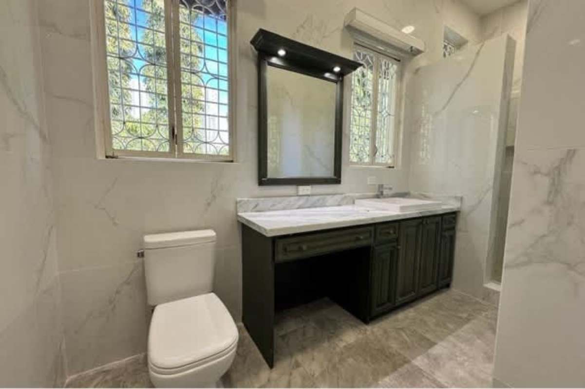 Bathroom with marble counters and large windows Altos del Golf Panama
