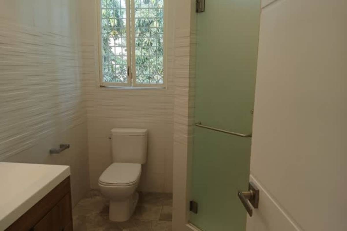 Bathroom featuring marble countertop dual sinks and windows in Altos del Golf Panama