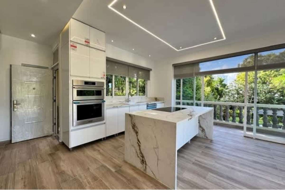 Minimalist bedroom with tile flooring built-in closets luxury estate Altos del Golf Panama