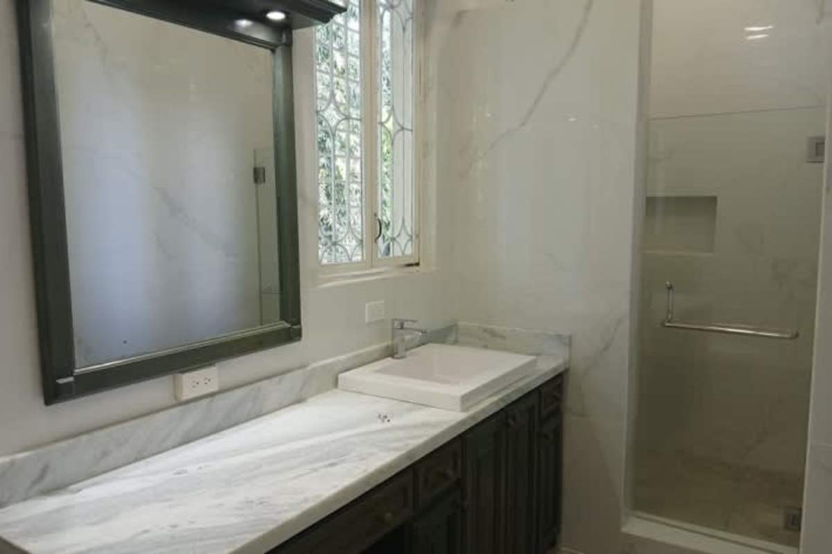 Bathroom with marble counter glass shower light colors in Panama luxury estate Altos del Golf