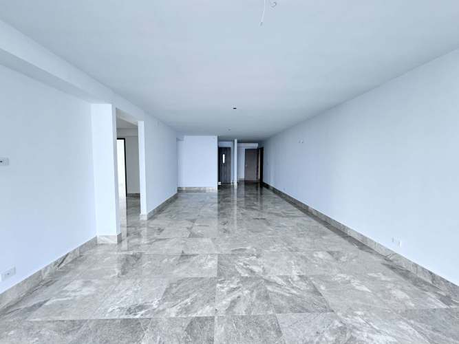 Bedroom featuring built-in closet and large windows with city views at PH Bay View Panama City