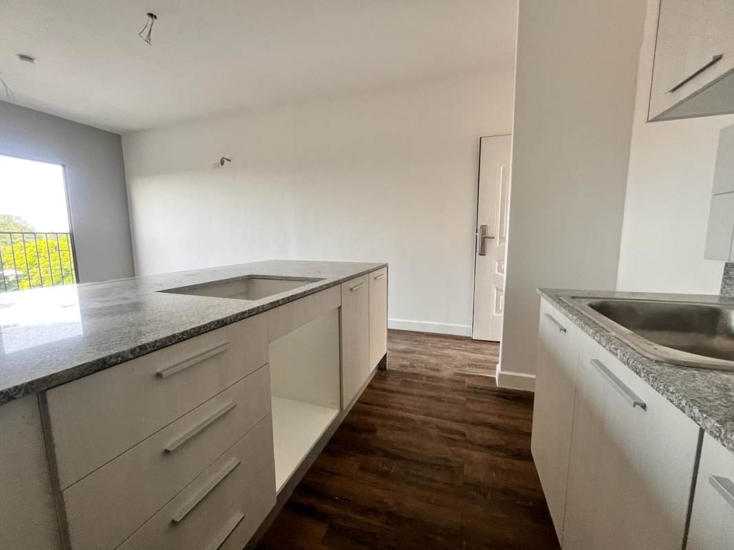 Bright living dining room with large windows and wood floors in Las Acacias Panama