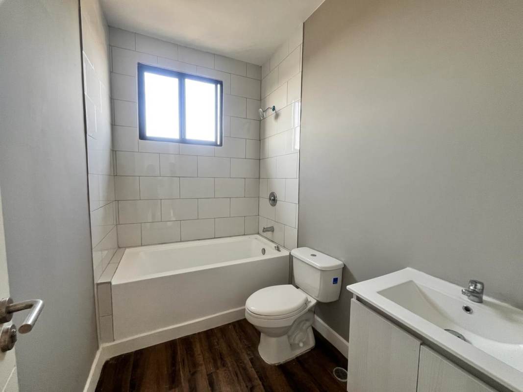 Stylish kitchen with granite countertops and ample cabinets in Las Acacias apartment