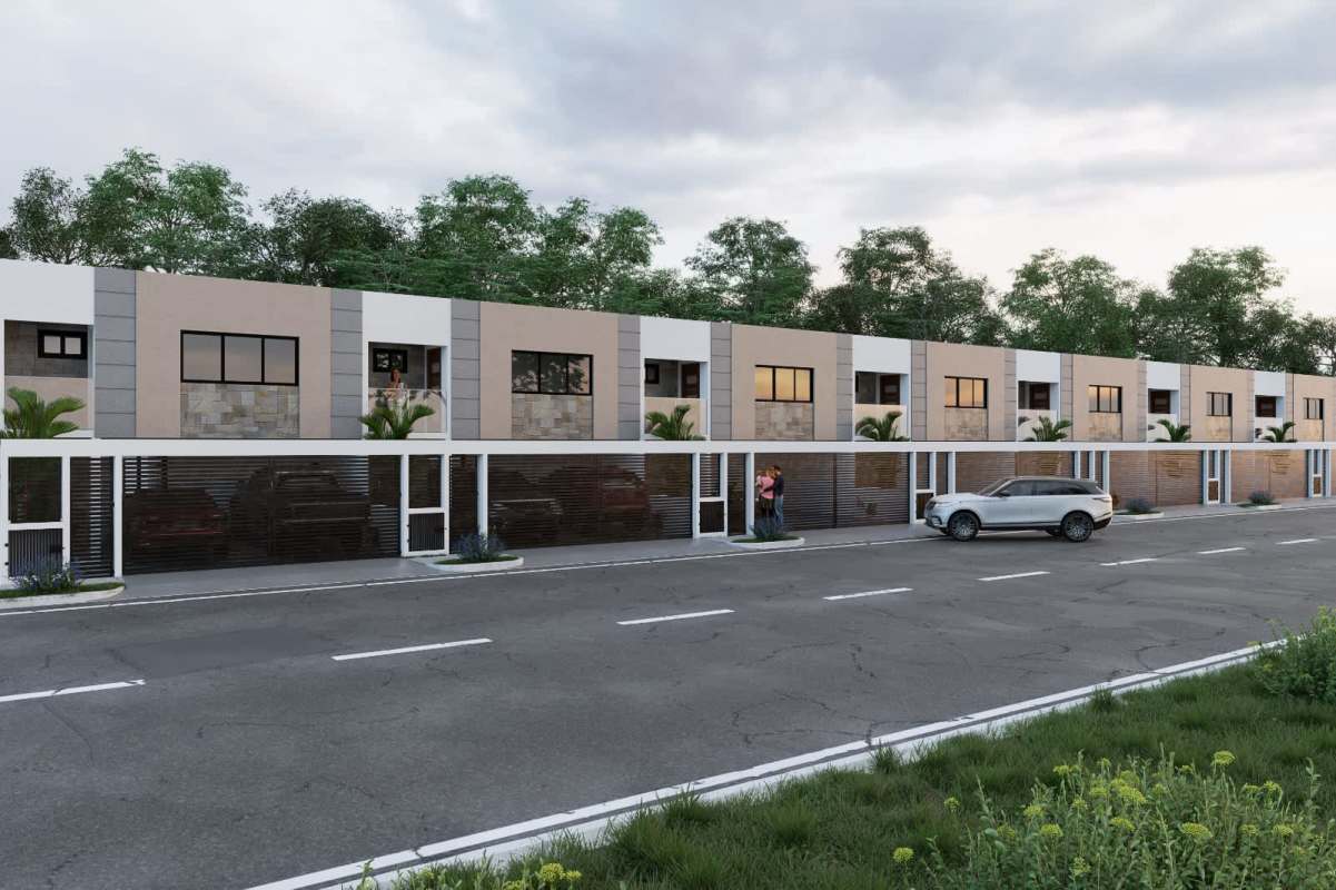 Front facade of new Casa Vita duplexes with large windows, balconies, landscaping and covered parking Panama City