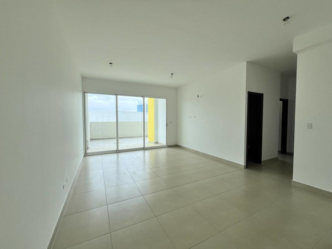 Living and dining area with natural light balcony access PH Kings Park Condado del Rey