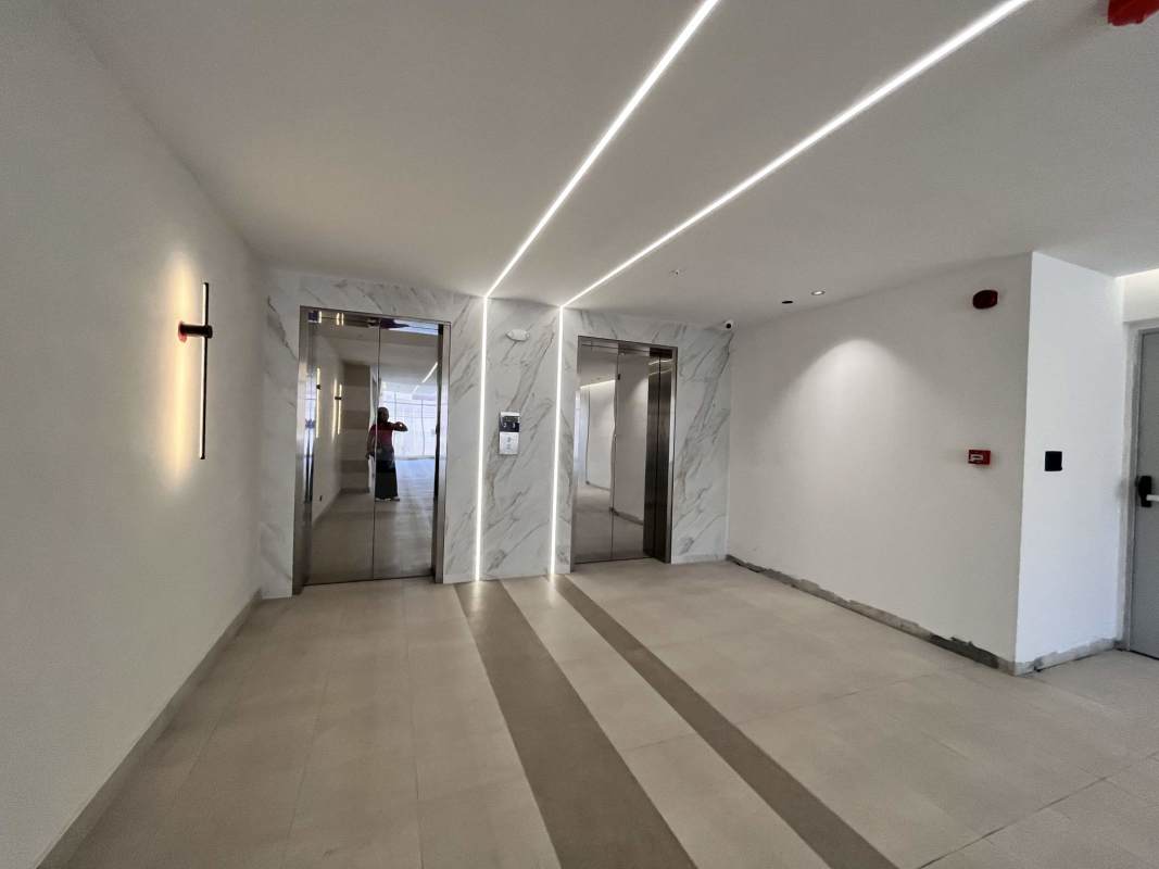 Modern minimalist office with wood flooring floor-to-ceiling windows Park Square Medical Center Panama