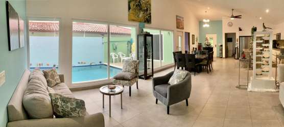Open plan living dining room with pool views, large windows, ceramic floors - Coronado Panama
