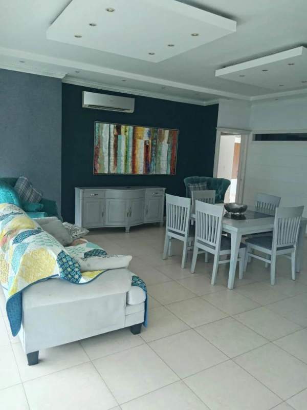 Open living and dining area with porcelain floors and ocean view balcony Belle View Tower Panama