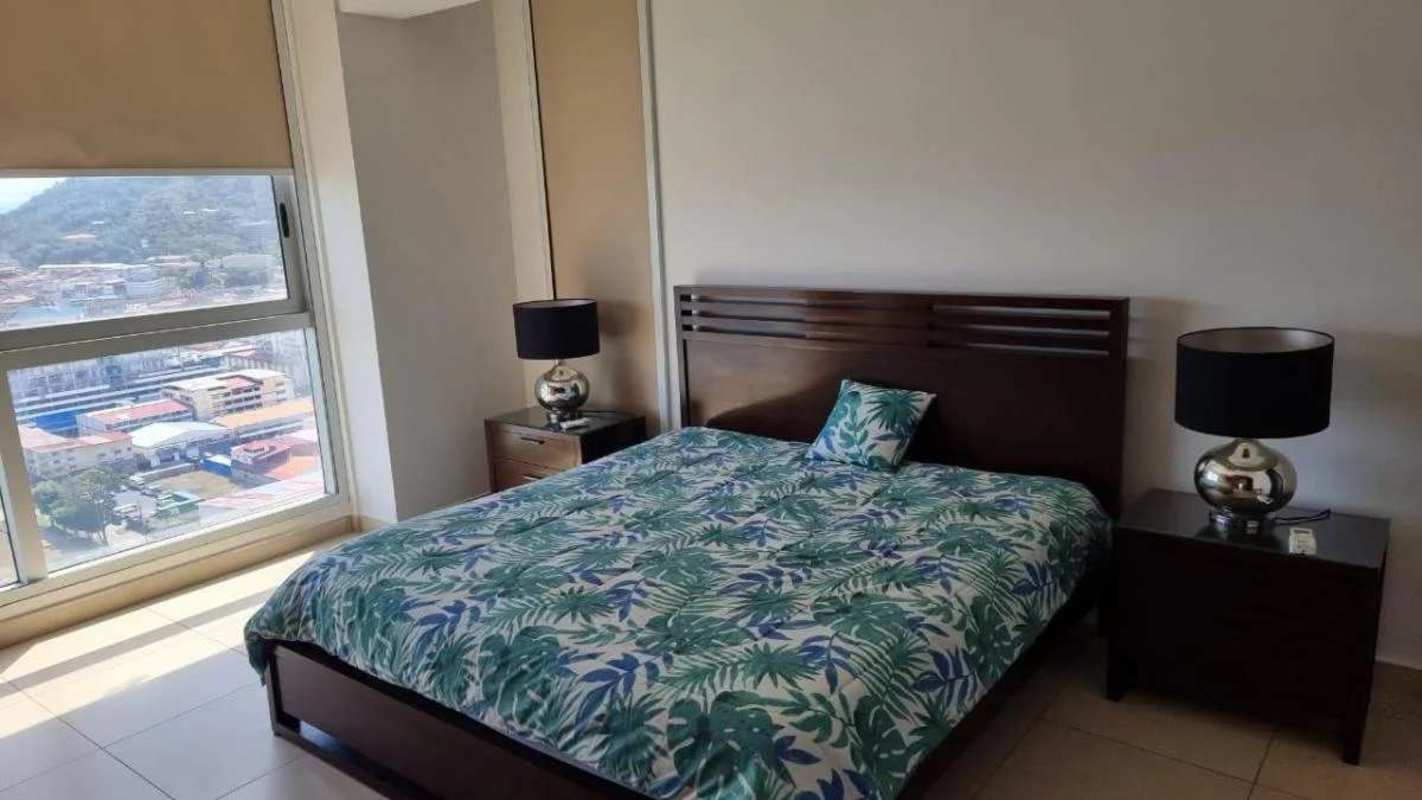 Modern bedroom with wide windows offering Casco Viejo and ocean views PH BICSA Tower Panama City