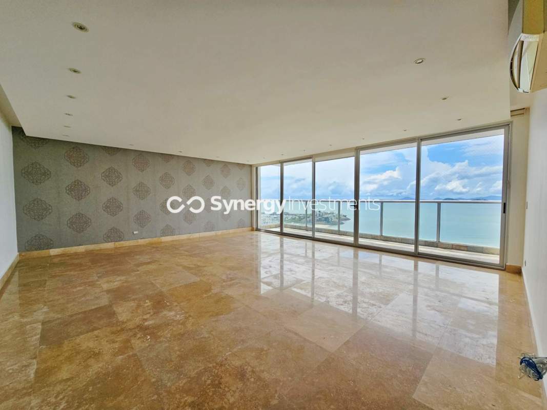 Living room with floor-to-ceiling windows panoramic ocean skyline view marble floors at Q Tower