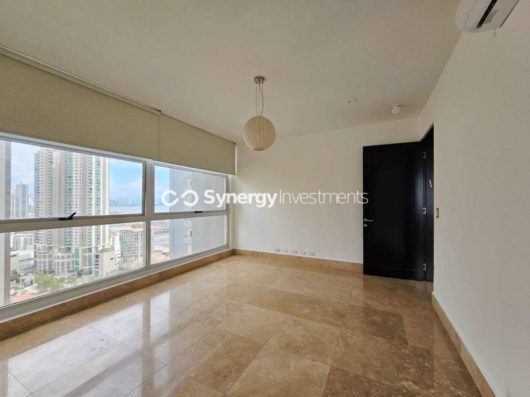 Modern bedroom large windows city ocean view marble floors Q Tower Punta Pacifica Panama