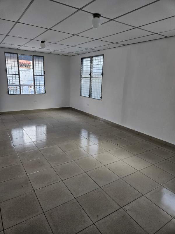 Simple bathroom with tile walls, walk-in shower and toilet in Don Bosco house for sale Panama City