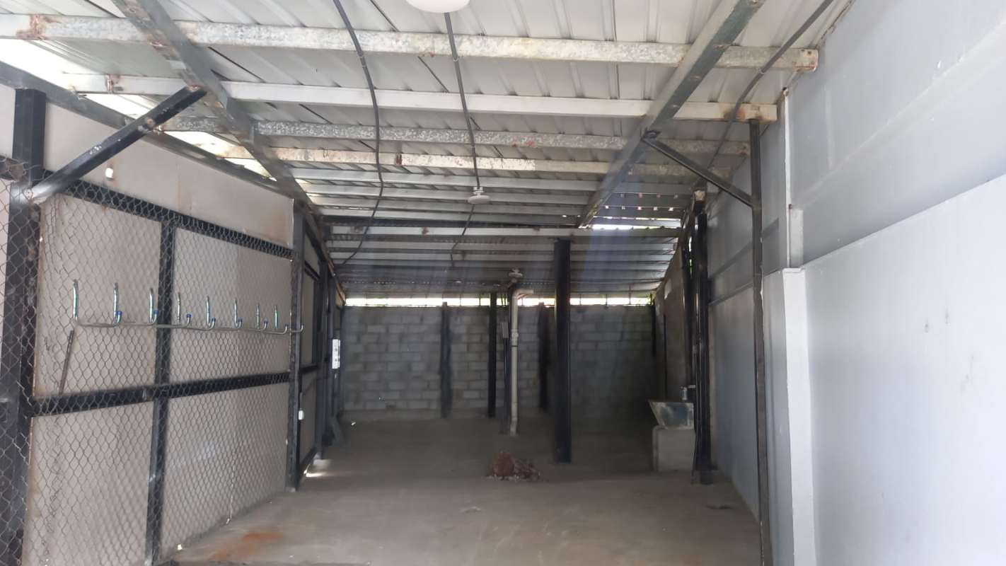 Industrial style enclosed warehouse storage with metal fencing in La Loma commercial area Panama City
