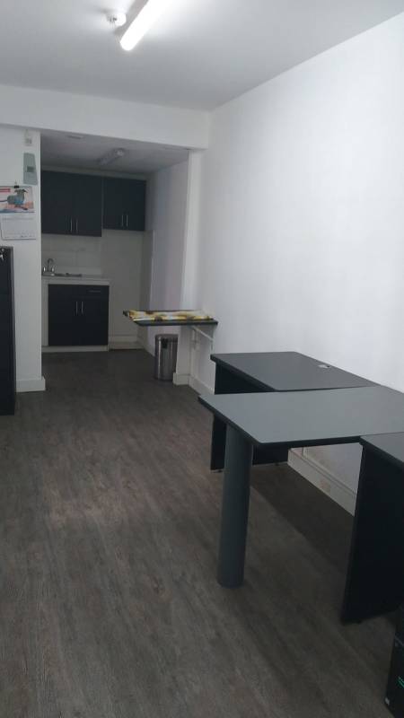 Black and white modern kitchenette with stainless sink in La Loma commercial office Panama