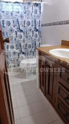 Dining area with large windows and traditional finishes in residential house Panama