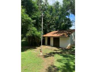 Small rustic guest building with clay tile roof in landscaped garden in Chitré Panama