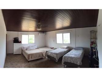 Rolling green pastures with trees and open land on farm property in Soná Panama