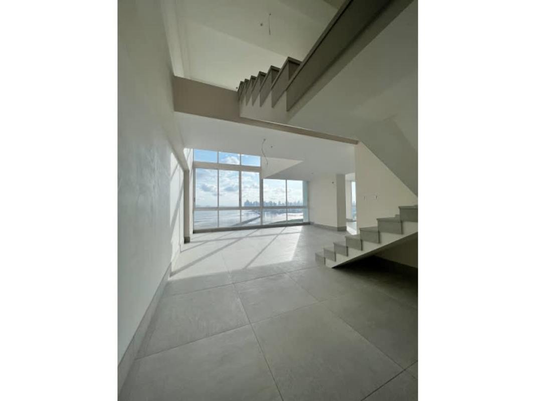 Modern penthouse living room with floor-to-ceiling windows overlooking ocean Costa del Este