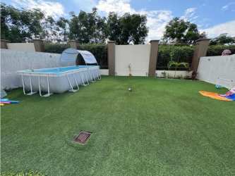 Covered terrace with artificial lawn patio behind duplex house PH Palmia Woodlands