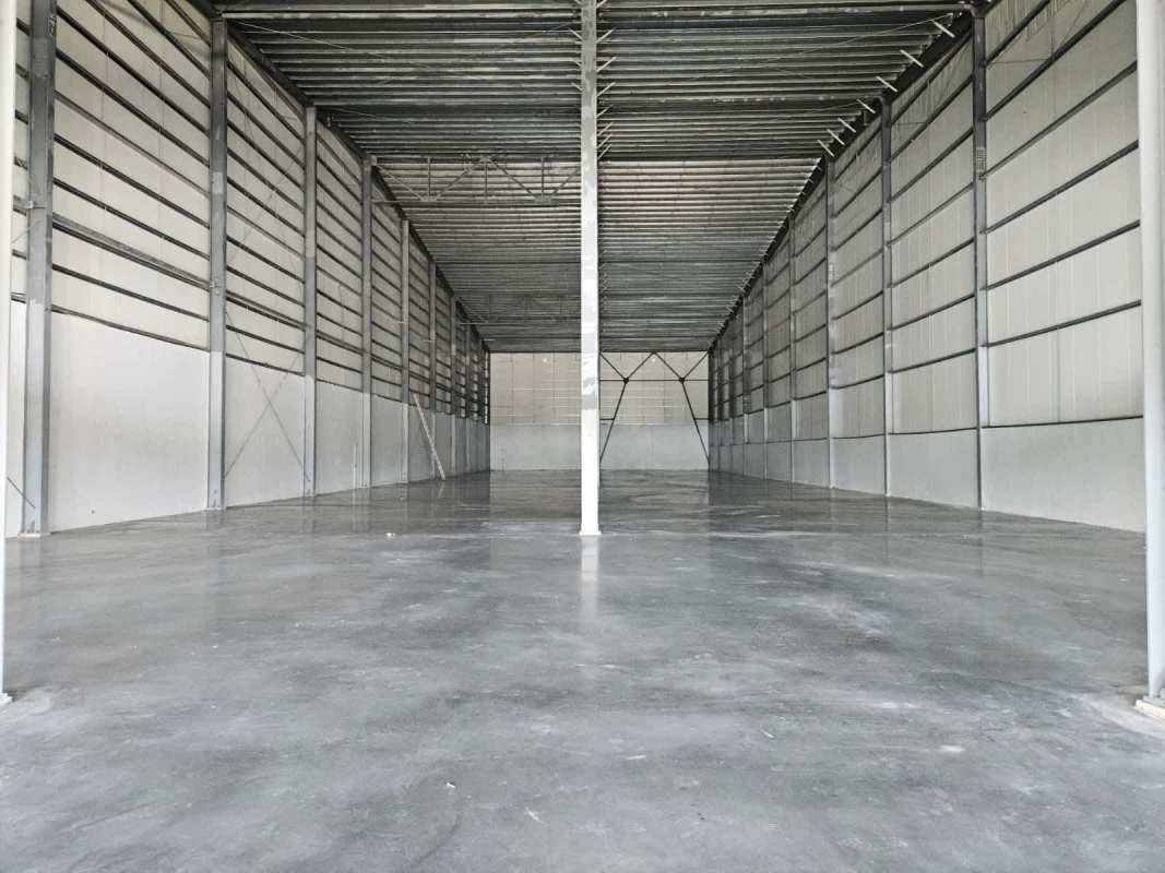 Empty industrial warehouse with metal beams and concrete floor near Rod Carew stadium Panama
