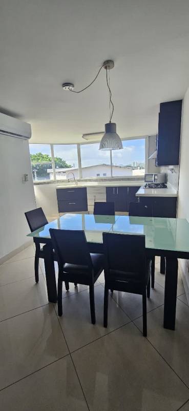 Contemporary kitchen with black-white cabinetry, granite, pendant lights in PH San Miguelito Suites