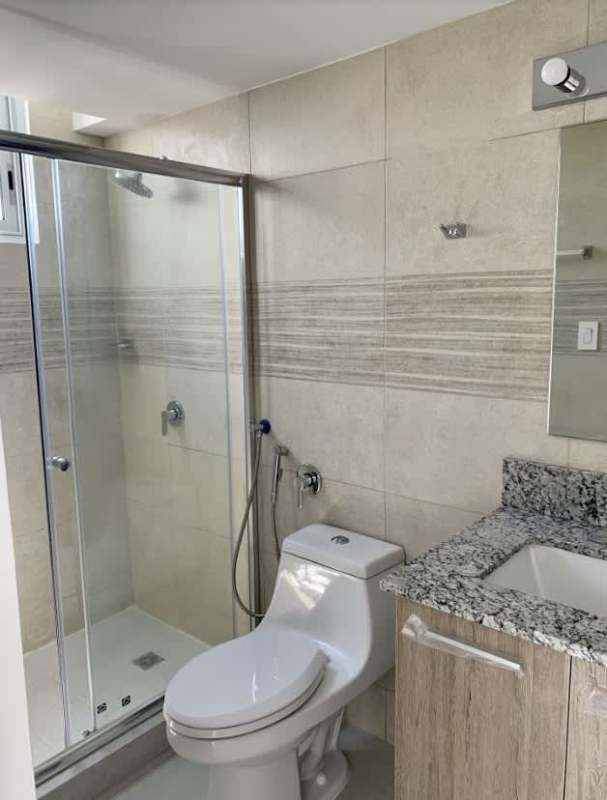 Modern bathroom with glass shower enclosure granite vanity tile accents PH Green Wood Tumba Muerto