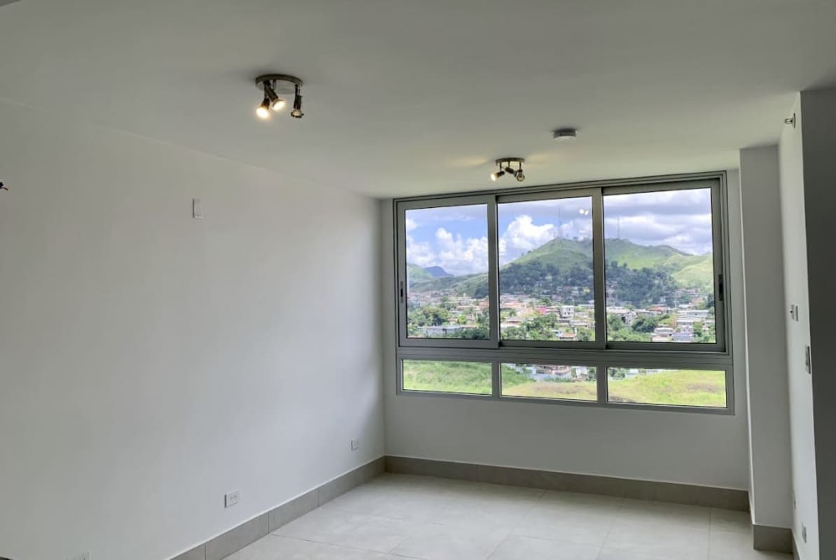 Bright living room with large window panoramic city mountain view tiled floors PH Green Wood