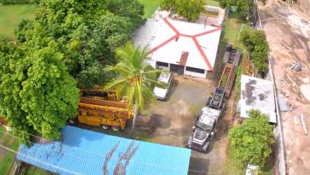 Industrial facility with warehouse building large paved yard and vehicles in Nueva Gorgona Panama