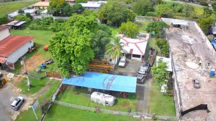 Aerial residential lot with green yard, parking, storage and trees Nueva Gorgona Panama