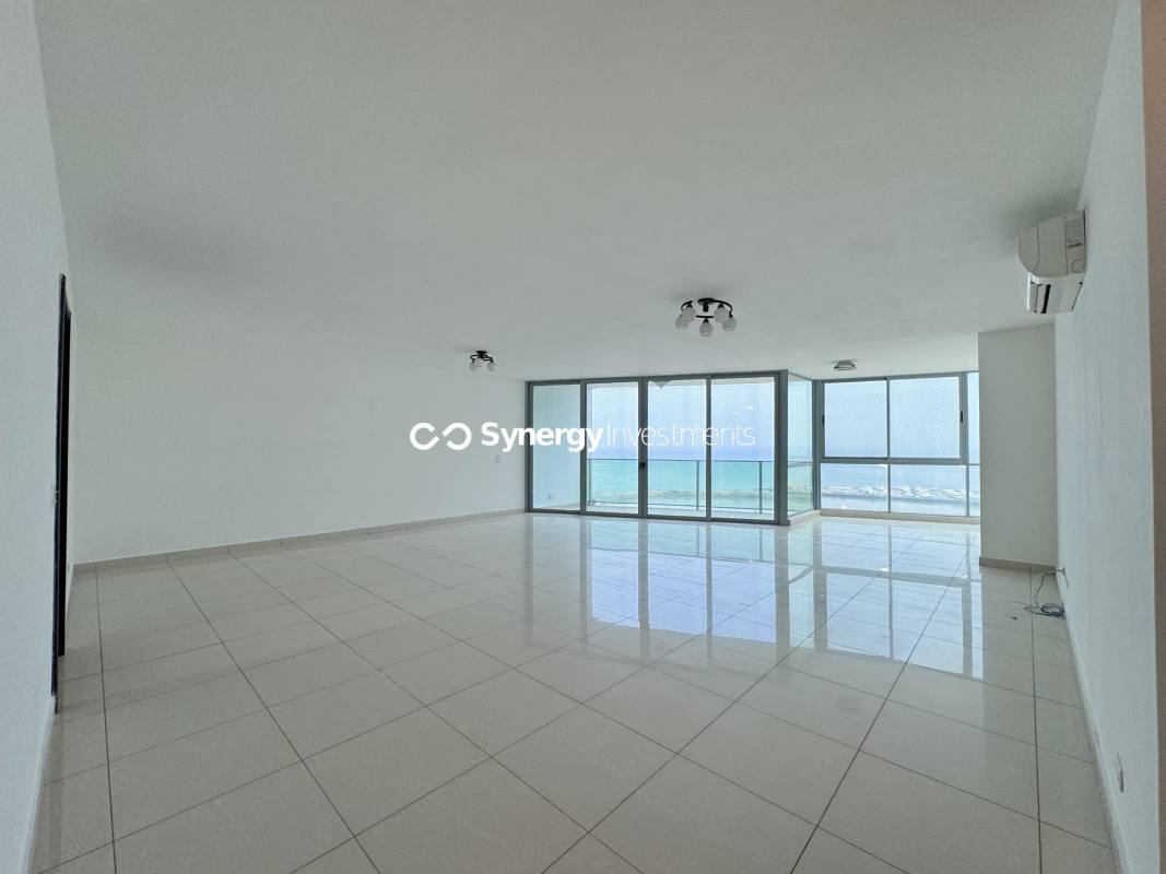 Large balcony terrace with glass railing overlooking city skyline and Pacific Ocean PH Allure Panama