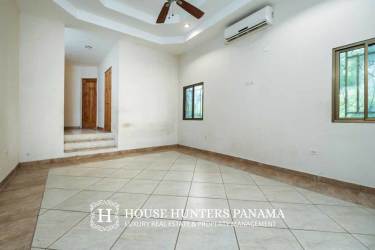Empty living room with tray ceiling, ceramic floors in luxury estate Sortova Panama