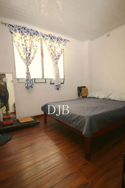 Cozy living room with sofas, TV stand, stone accent wall in Santa Isabel Pacora Panama