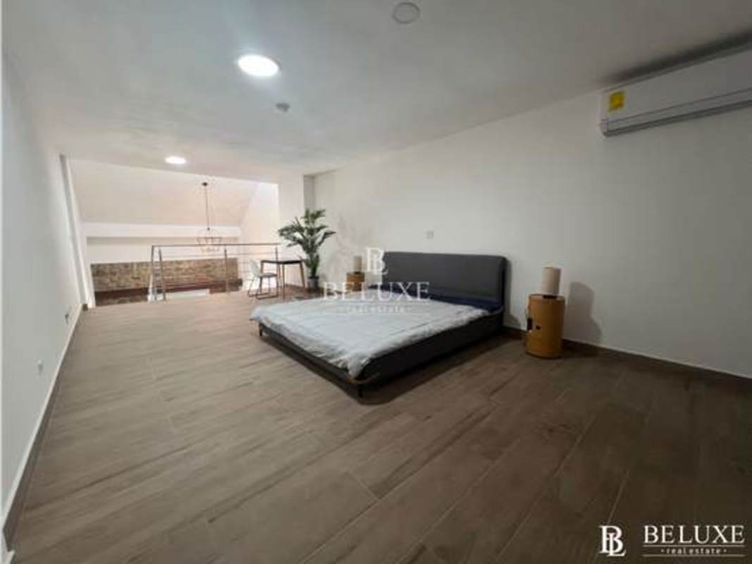 Contemporary bathroom with subway tiles, exposed stone, glass shower in Casco Viejo Panama loft apartment