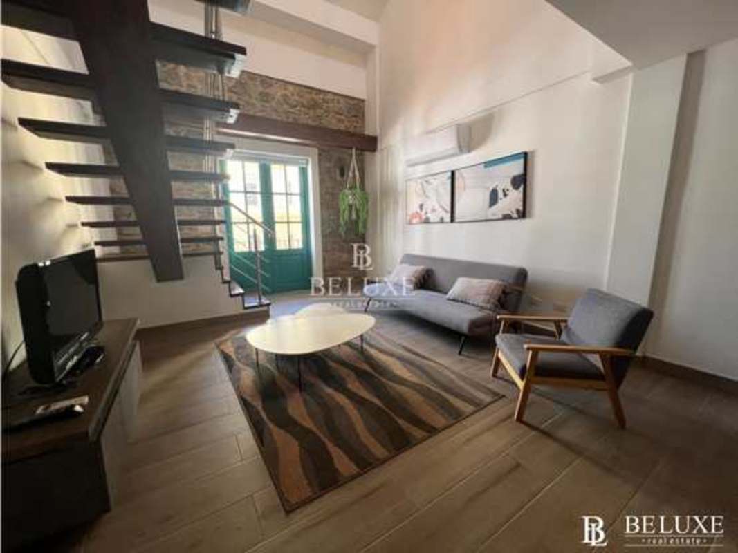 Updated kitchen with wood cabinets, stainless appliances, modern finishes in Casco Viejo historic building