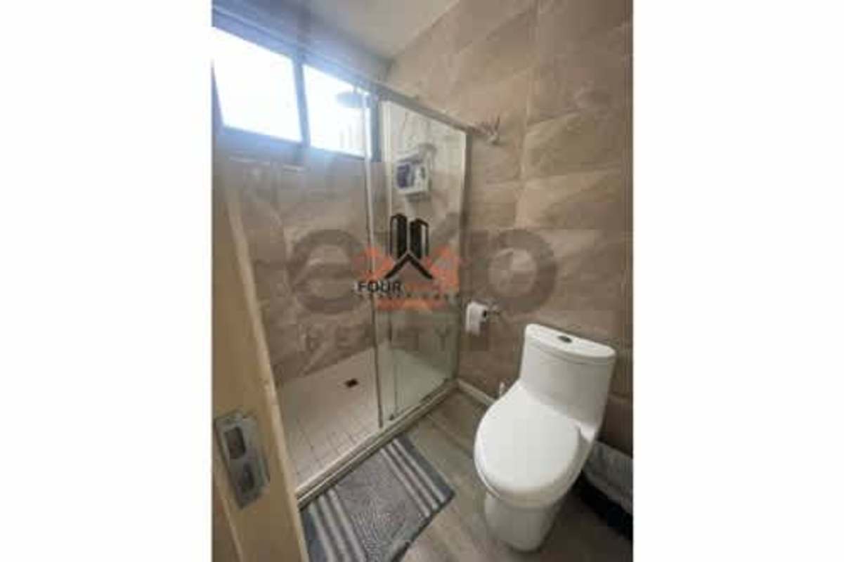 Rooftop pool with ocean views and lounge area at PH Balboa Bay Panama City