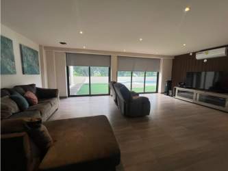 Luxurious master bedroom with balcony and garden pool views Nativa Panama Pacifico